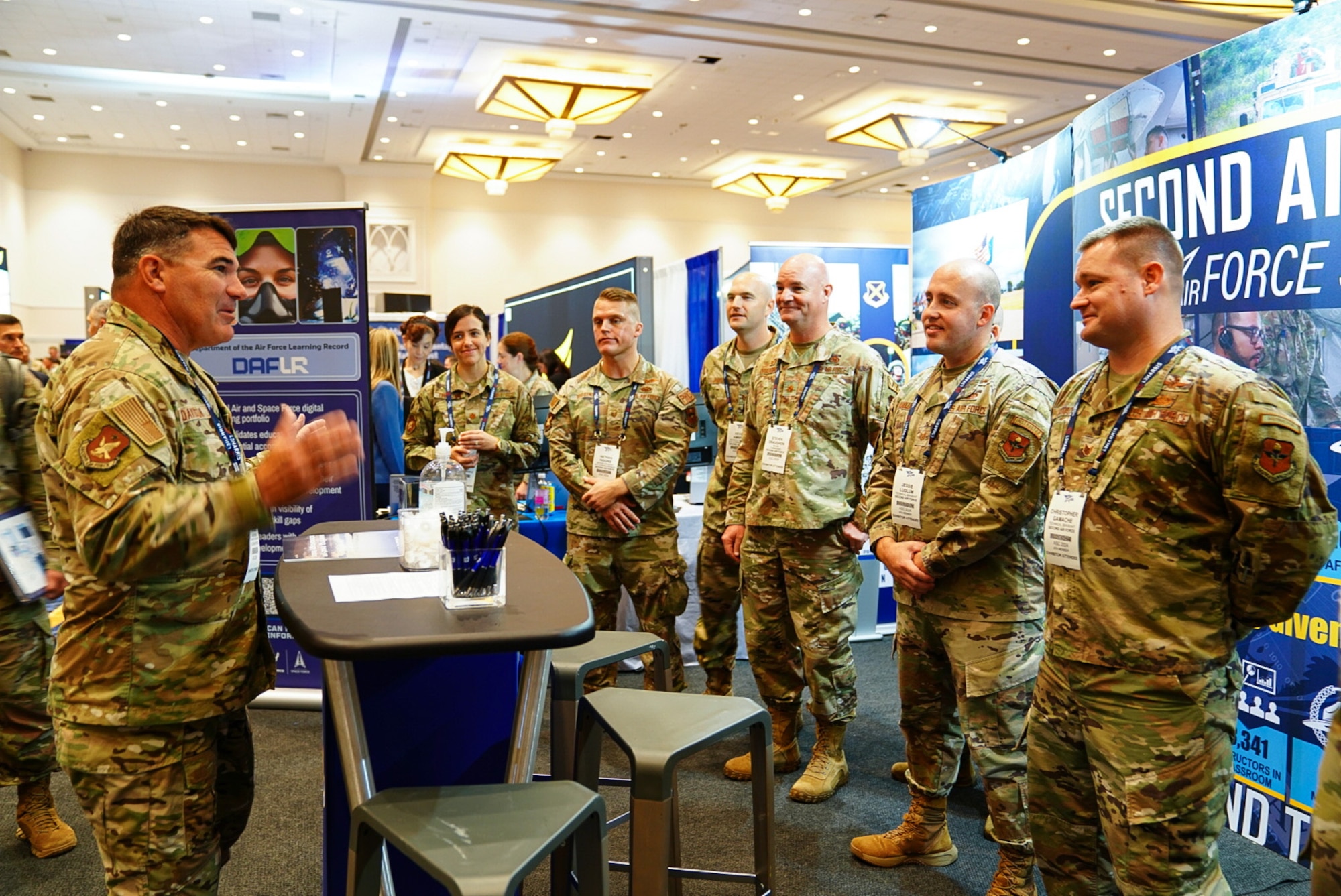 Maj. Gen. Wolfe Davidson, Second Air Force commander, huddles with the Second Air Force exhibit booth leads before the exhibit hall opens at the Air, Space and Cyber Conference, National Harbor, Md., Sept. 16, 2024.