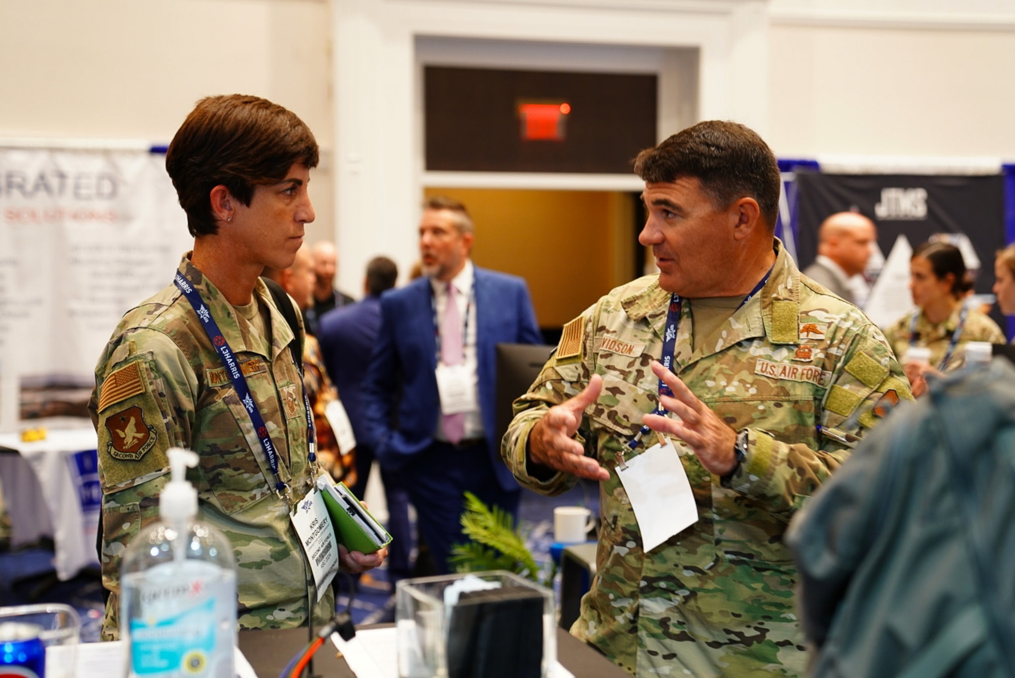 Maj. Gen. Wolfe Davidson, Second Air Force commander, talks to Chief Master Sgt. Kristina Montgomery, Second Air Force command chief, at the Air, Space and Cyber Conference, National Harbor, Md., Sept 16, 2024.