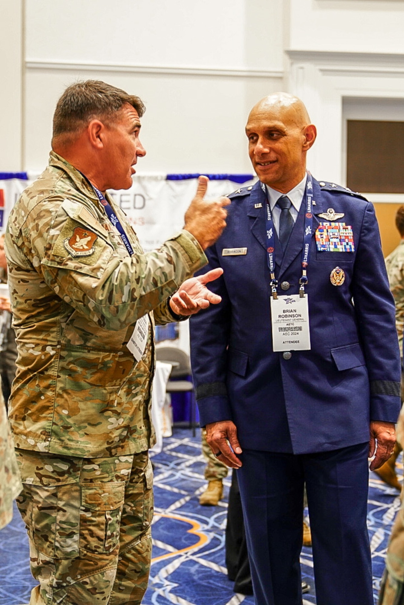 Lt. Gen. Brian Robinson, commander of Air Education and Training Command, speaks with Maj. Gen. Wolfe Davidson, Second Air Force commander, at the Air, Space and Cyber Conference, National Harbor, Md., Sept. 16, 2024.