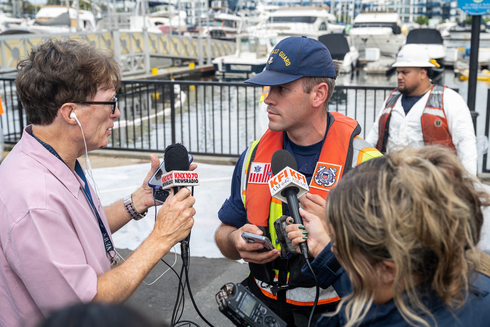 Coast Guard Petty Officer 2nd Class Brian Bell, a marine science technician from Sector Los Angeles-Long Beach, talks to reporters.