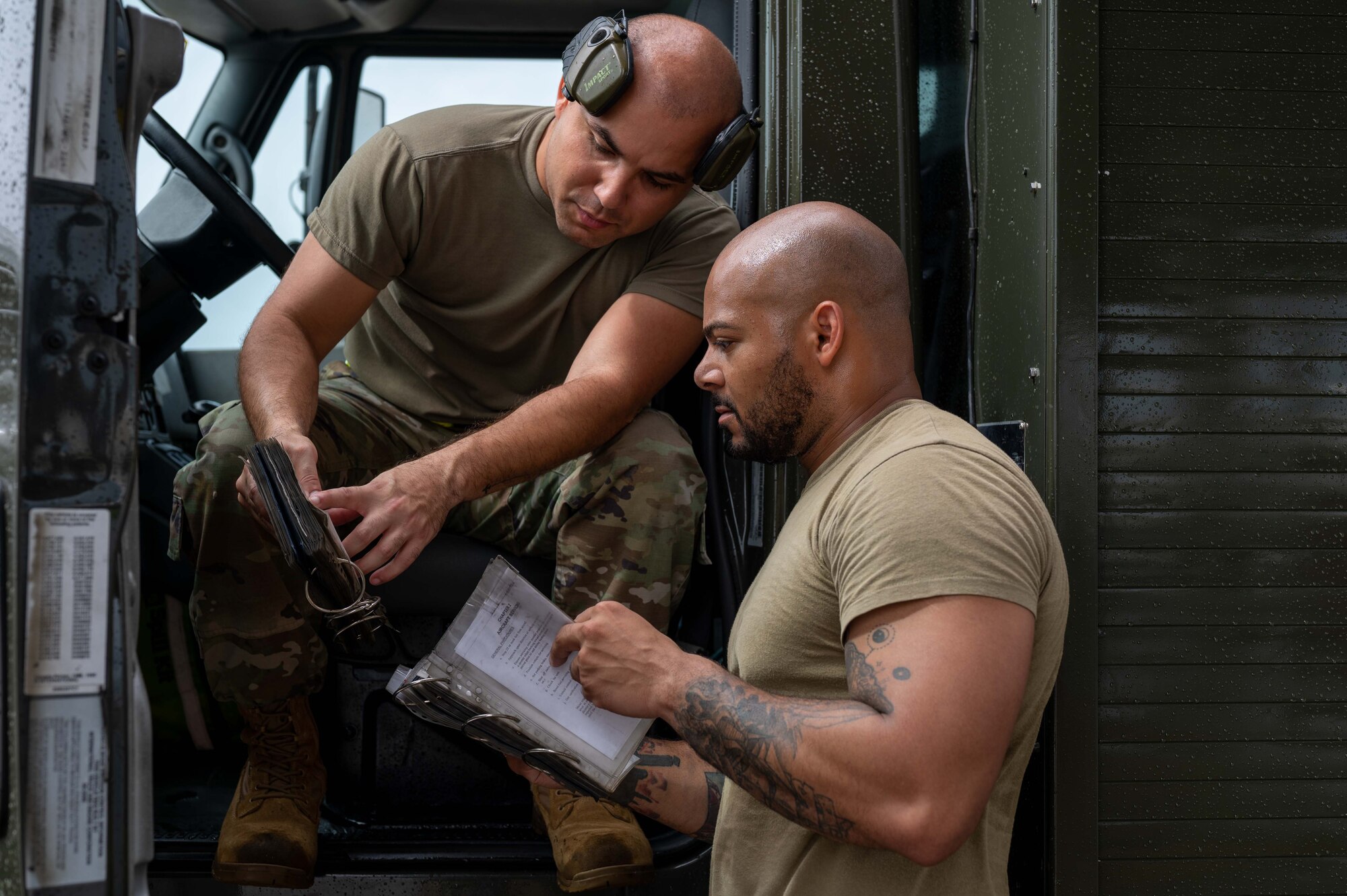 U.S. Air Force Senior Airman Andre Burgos Torres, left, 18th Logistics Readiness Squadron petroleum, oils and lubricants technician, and Staff Sgt. Anthony Davis, 18th LRS POL fuels service center supervisor, follow safety regulation check lists in preparation to refuel aircraft during an agile combat employment exercise, Shogun Shield, at Kadena Air Base, Japan, Sept. 18, 2024.