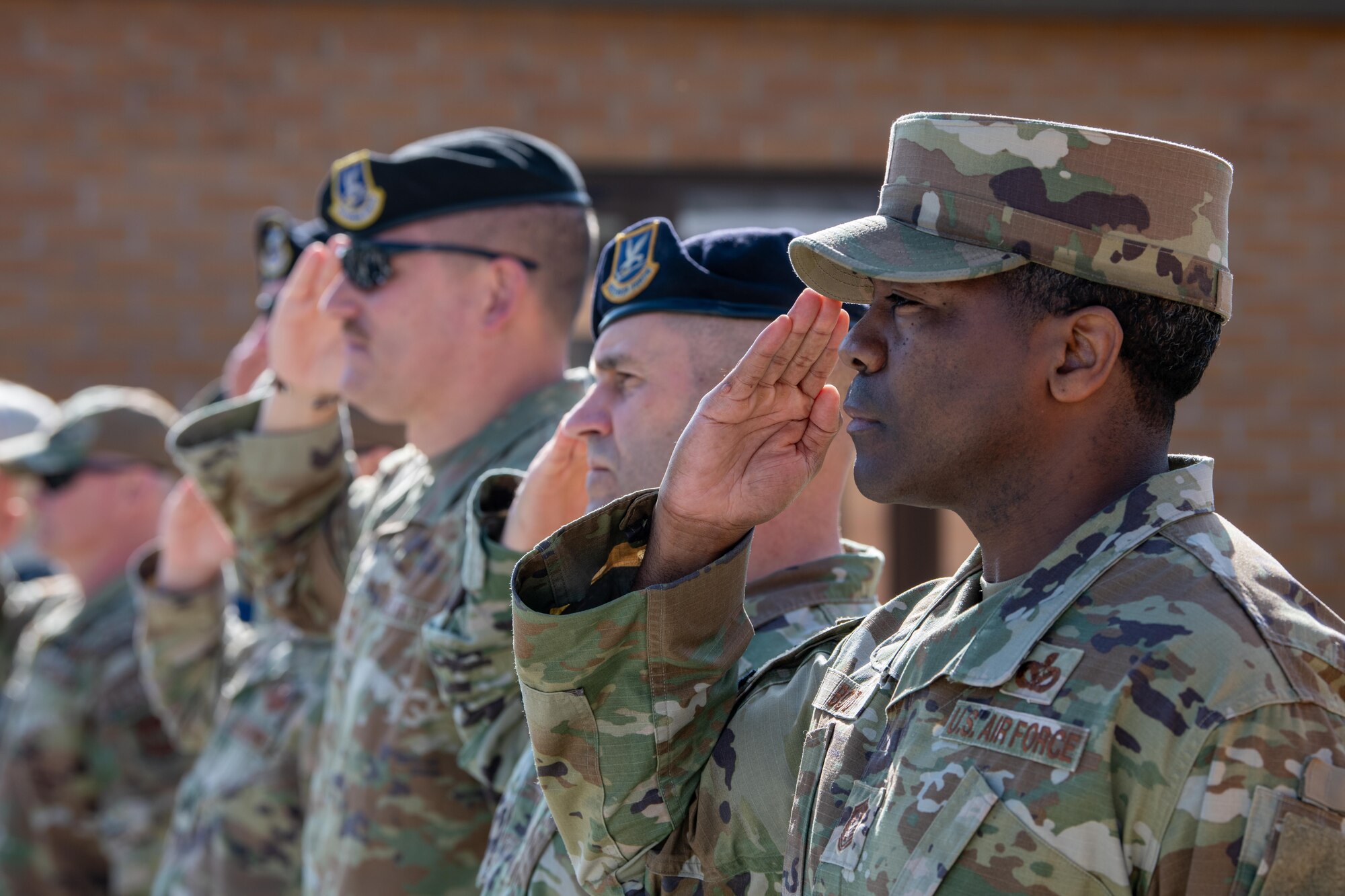 Airmen salute during a retreat ceremony