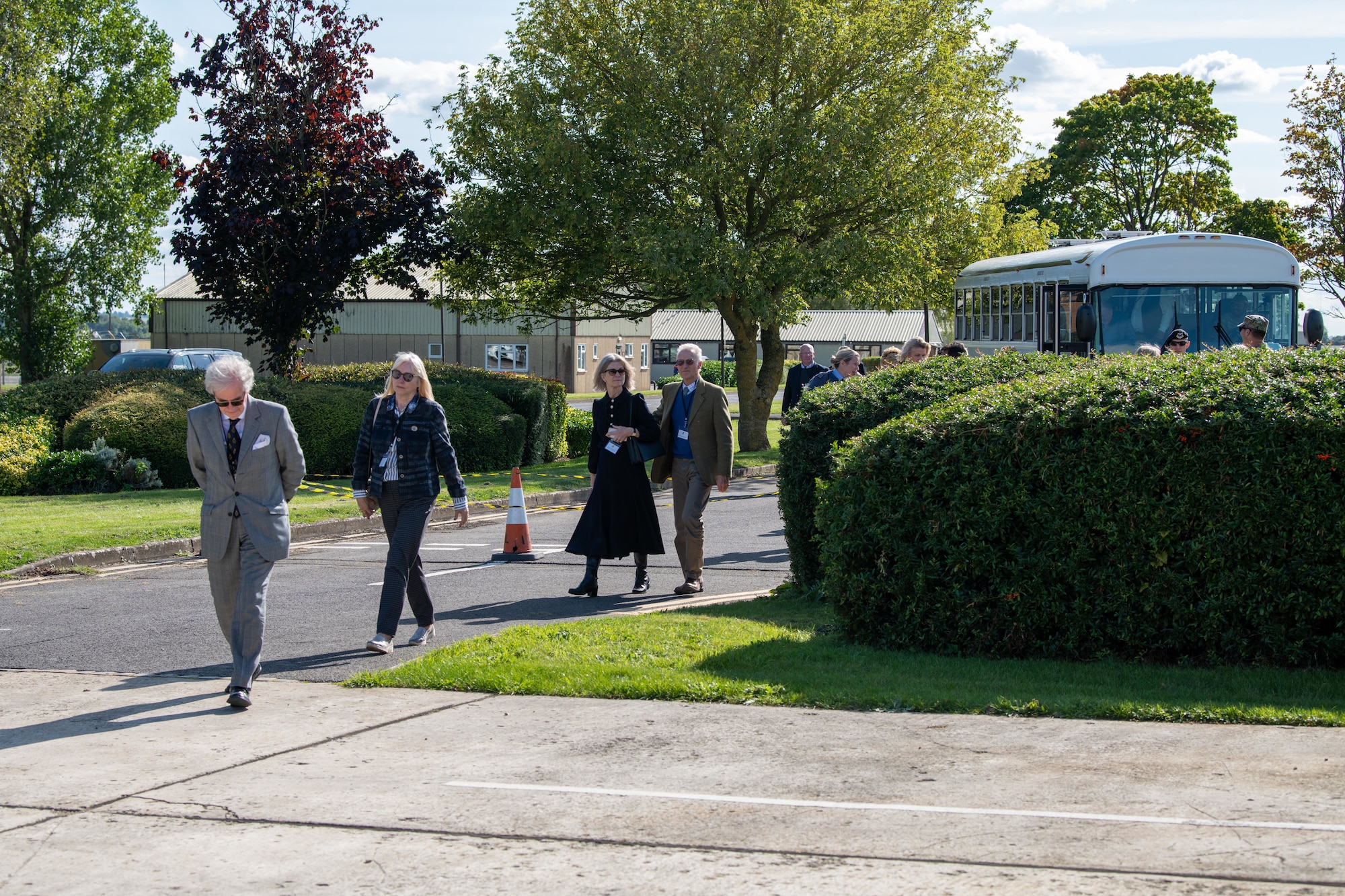 Attendees depart a shuttle bus during an immersion tour