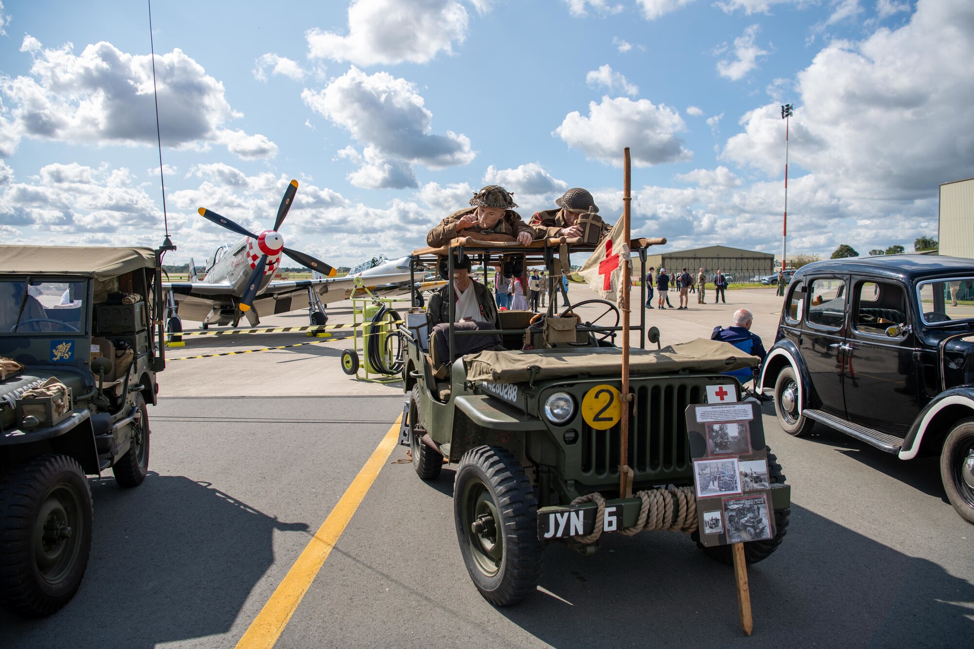 Vintage vehicles are displayed on the taxiway during the RAF Fairford 80th Anniversary Heritage Day