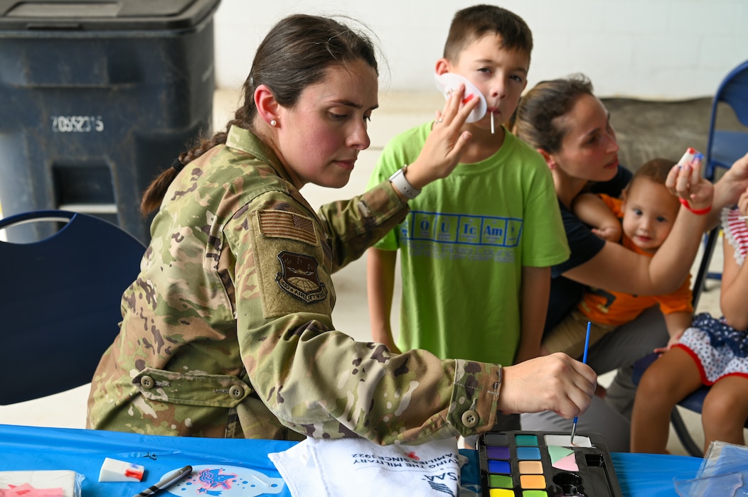 1st Lt. Deborah Slusher, a 433rd Airlift Wing public affairs officer, paints the face of a young boy at the Company Grade Officers’ Council booth during the Alamo Wing’s Family Day at Joint Base San Antonio-Lackland, Texas Sept. 15, 2024.