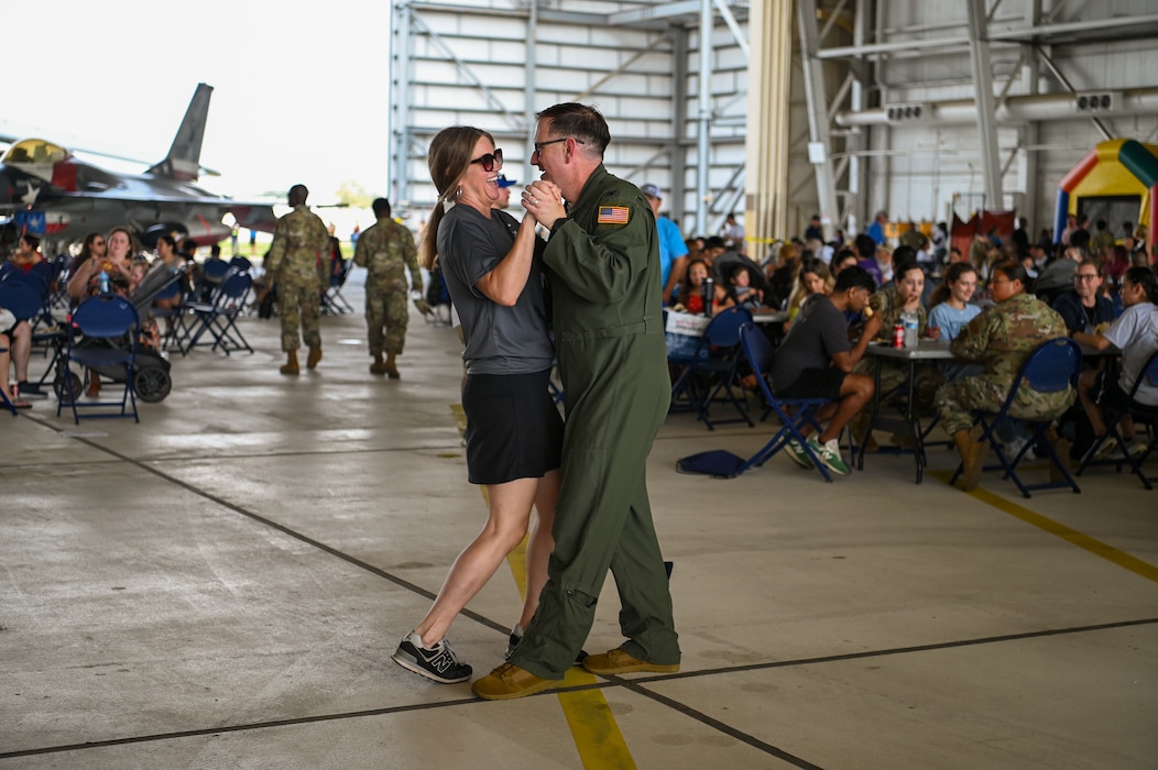 Col. Douglas Jeffrey, 433rd Airlift Wing commander, shares an impromptu dance with his wife, Molly, as a band plays during the Alamo Wing’s Family Day at Joint Base San Antonio-Lackland, Texas Sept. 15, 2024.