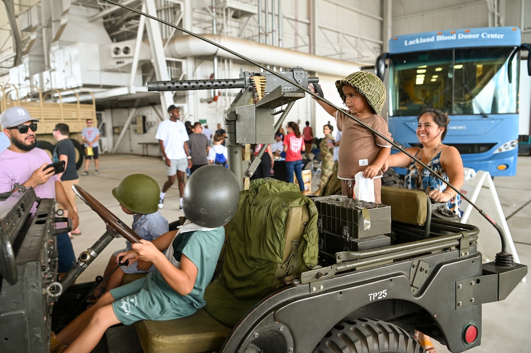 Three kids play on a replica of a World War Two-era jeep, one of the many military displays available during the Alamo Wing’s Family Day at Joint Base San Antonio-Lackland, Texas Sept. 15, 2024.