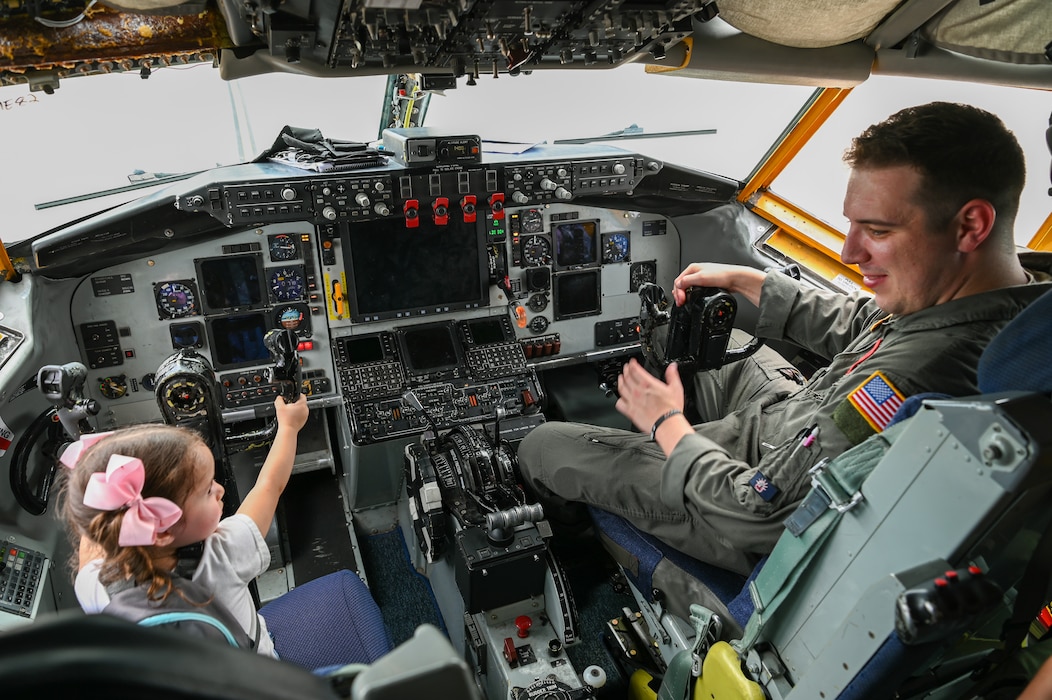 A 465th Air Refueling Squadron aircrew member shows a little girl how the flight controls of a KC-135 Stratotanker from Tinker Air Force Base, Okla. work during a static display at Joint Base San Antonio-Lackland, Texas Sept. 15, 2024.