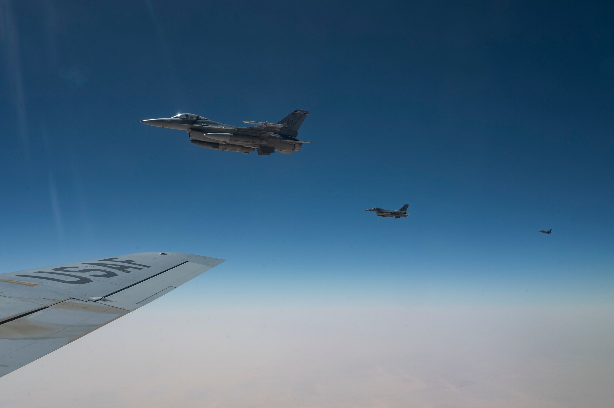 Three U.S. Air Force F-16 Fighting Falcons assigned to the 510th Expeditionary Fighter Squadron, Aviano Air Base, Italy, fly in formation with a KC-135 Stratotanker assigned to the 92nd Expeditionary Air Refueling Squadron, Fairchild Air Force Base, Washington, after refueling for Exercise Ballast Cannon, over the U.S. Central Command area of responsibility, Sept. 18, 2024. (U.S. Air Force photo)