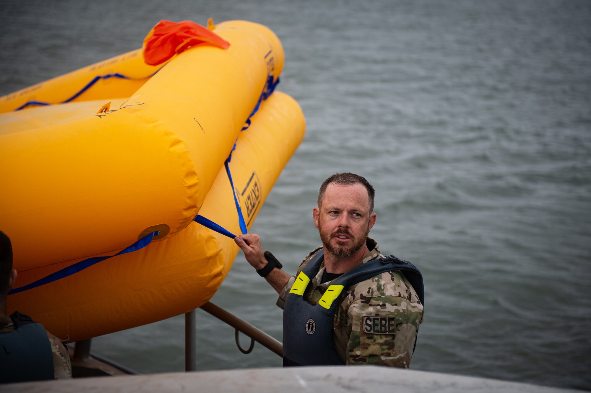 U.S. Air Force Master Sgt. Derreck Day, 436th Operations Support Squadron Survival, Evasion, Resistance and Escape flight chief, holds onto a life raft during Exercise Castaway 24-4 near Cape Henlopen State Park, Delaware, Sept. 18, 2024. Castaway 24-4 was a total force interagency training exercise designed to test and execute search and rescue procedures. (U.S. Air Force photo by Staff Sgt. Marco A. Gomez)