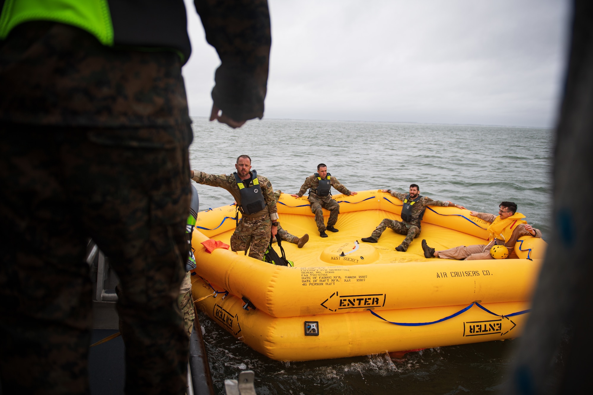 U.S. Airmen sit in a life raft during Exercise Castaway 24-4 near Cape Henlopen State Park, Delaware, Sept. 18, 2024. Castaway 24-4 was a total force interagency training exercise designed to test and execute search and rescue procedures. (U.S. Air Force photo by Staff Sgt. Marco A. Gomez)