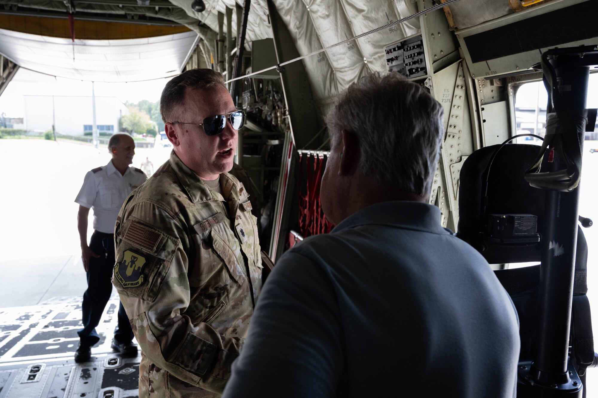 Active duty airman speaks with veteran.