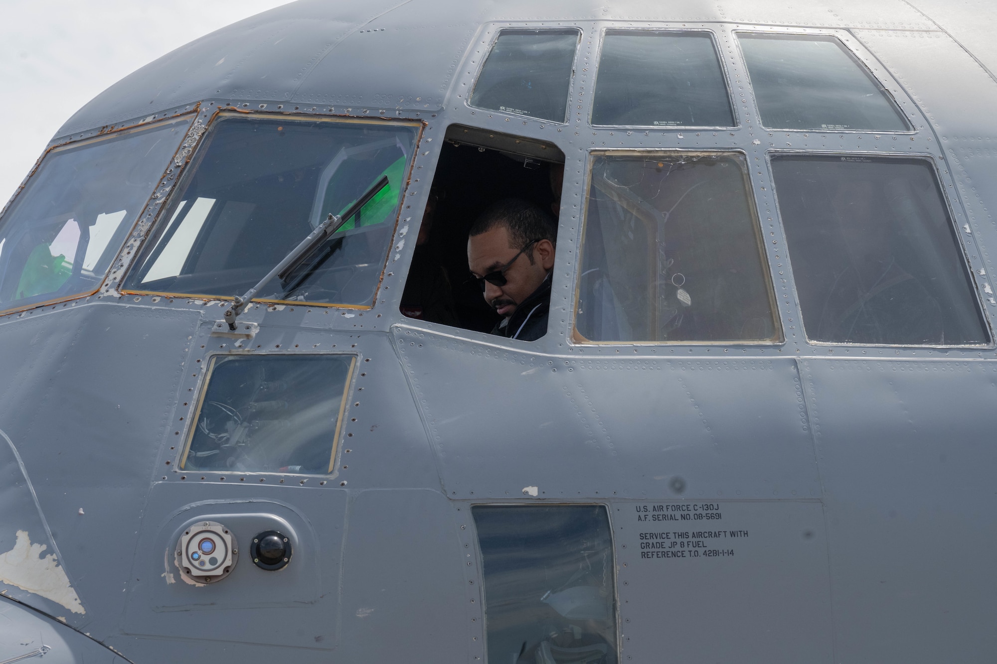 Veteran sits in the cockpit of a plane.