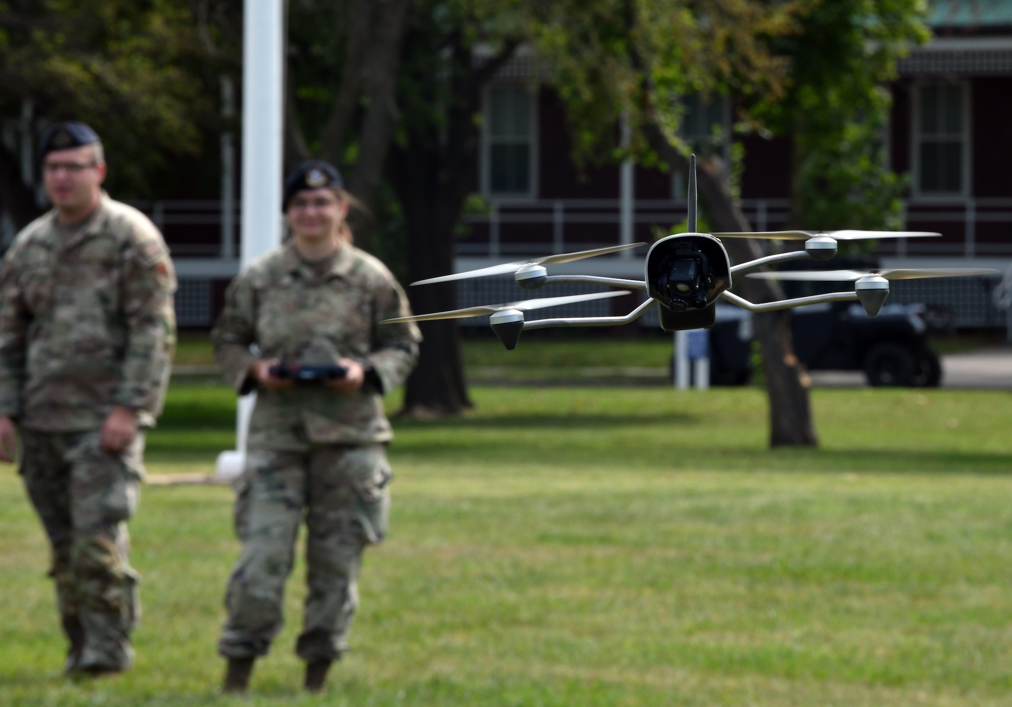 Airmen flying drone on parade grounds
