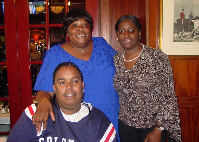 Two women and a man pose for a picture