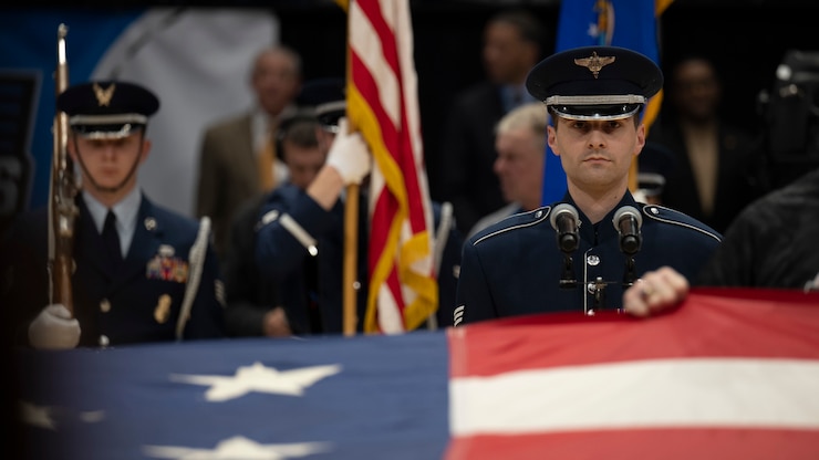 Marik Chrisman sings the national anthem at an NBA basketball court.