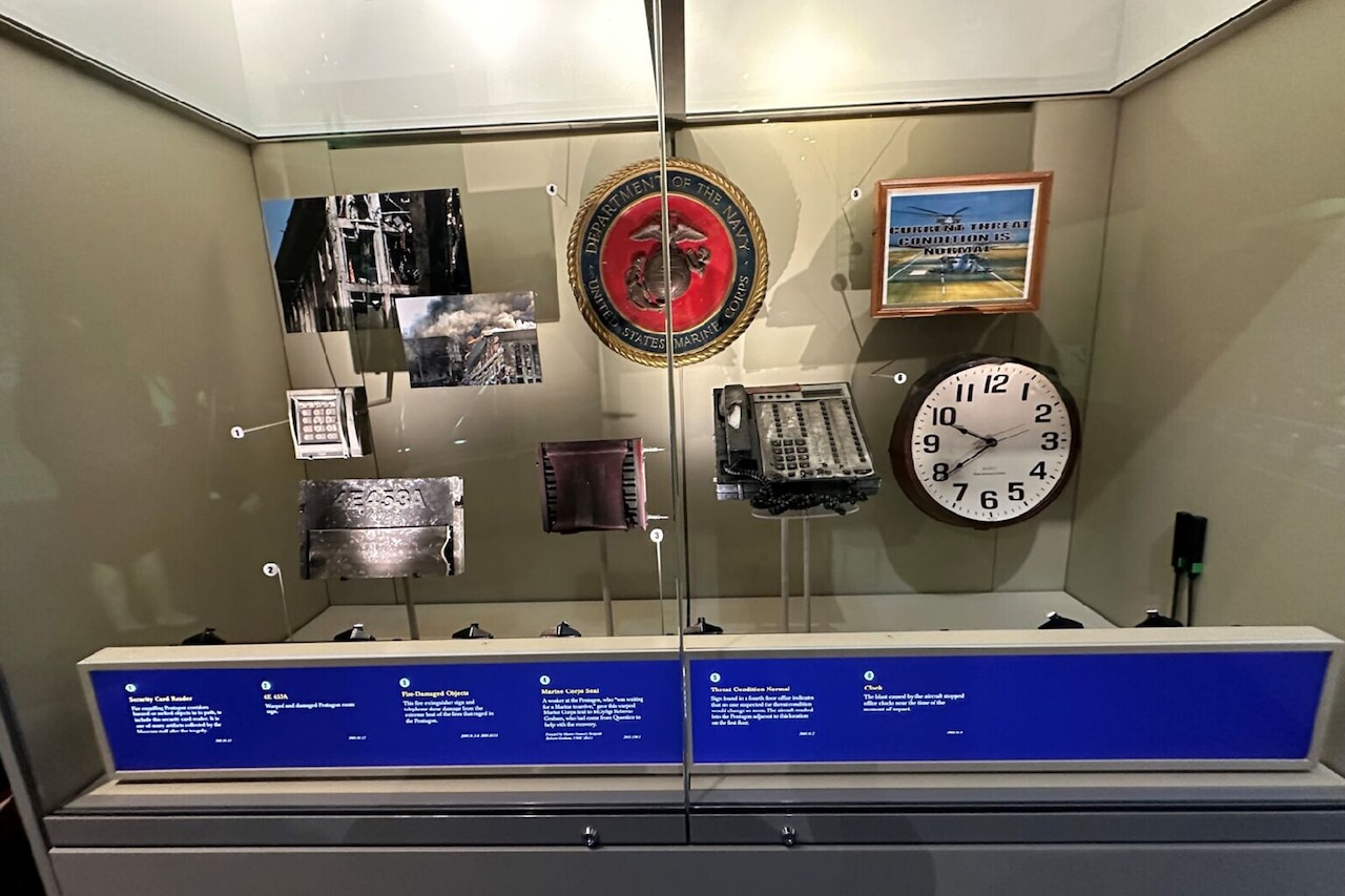 Broken and charred items are displayed in display case.