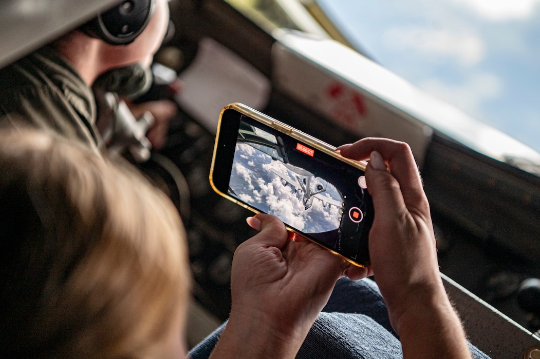 A military spouse films her husband, an A-10C Thunderbolt II pilot assigned to the 75th Fighter Squadron, during an aerial refueling operation performed by the aircrew from the 117th Air Refueling Wing, Sumpter Smith Joint National Guard Base, Birmingham, Alabama, at Moody Air Force Base, Georgia, Sept. 19, 2024. Airmen and Families were able to fly on a KC-135 Stratotanker and watch refueling operations. (U.S. Air Force photo by Senior Airman Leonid Soubbotine)