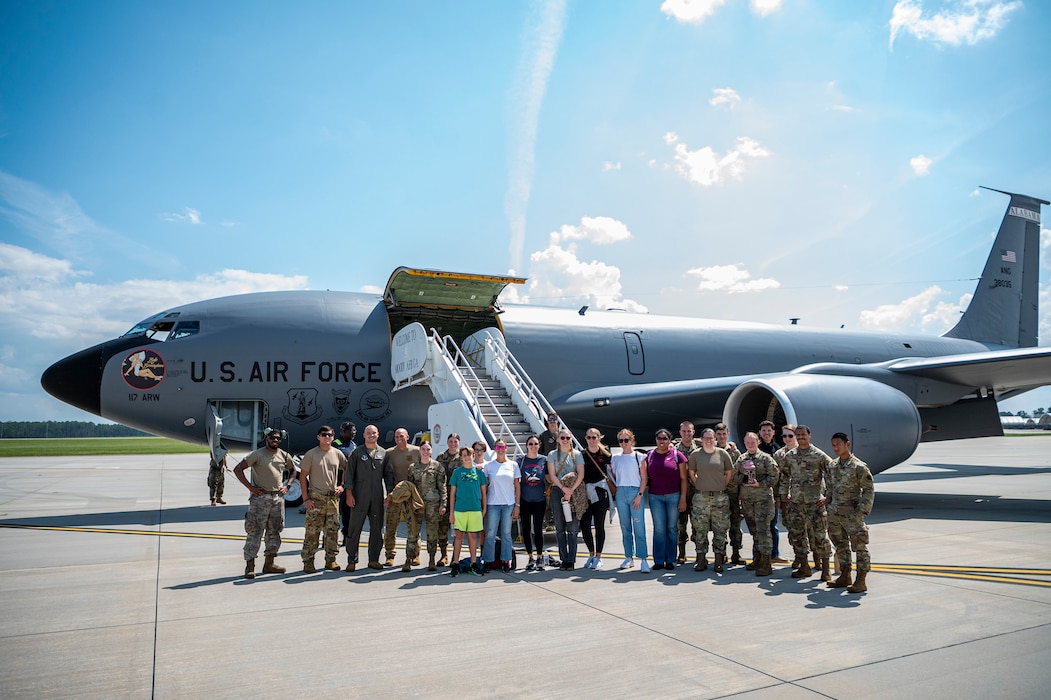 Military spouses, along with U.S. Air Force Airmen assigned to the 23rd Wing, and aircrew from the 117th Air Refueling Wing, Sumpter Smith Joint National Guard Base, Birmingham, Alabama, pose for a photo at Moody Air Force Base, Georgia, Sept. 19, 2024. Airmen and spouses were able to watch the aerial refueling operations from inside the KC-135 Stratotanker assigned to the 117th AFW. (U.S. Air Force photo by Senior Airman Leonid Soubbotine)