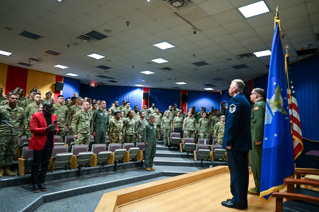 Col. Douglas Jeffrey, 433rd Airlift Wing commander, and Master Sgt. Raymond Johnson, a 433rd Aeromedical Evacuation Squadron aeromedical evacuation technician, stand at attention alongside their fellow 433rd AW Reserve Citizen Airmen during a military award ceremony at Joint Base San Antonio-Lackland, Texas Sep. 12, 2024.