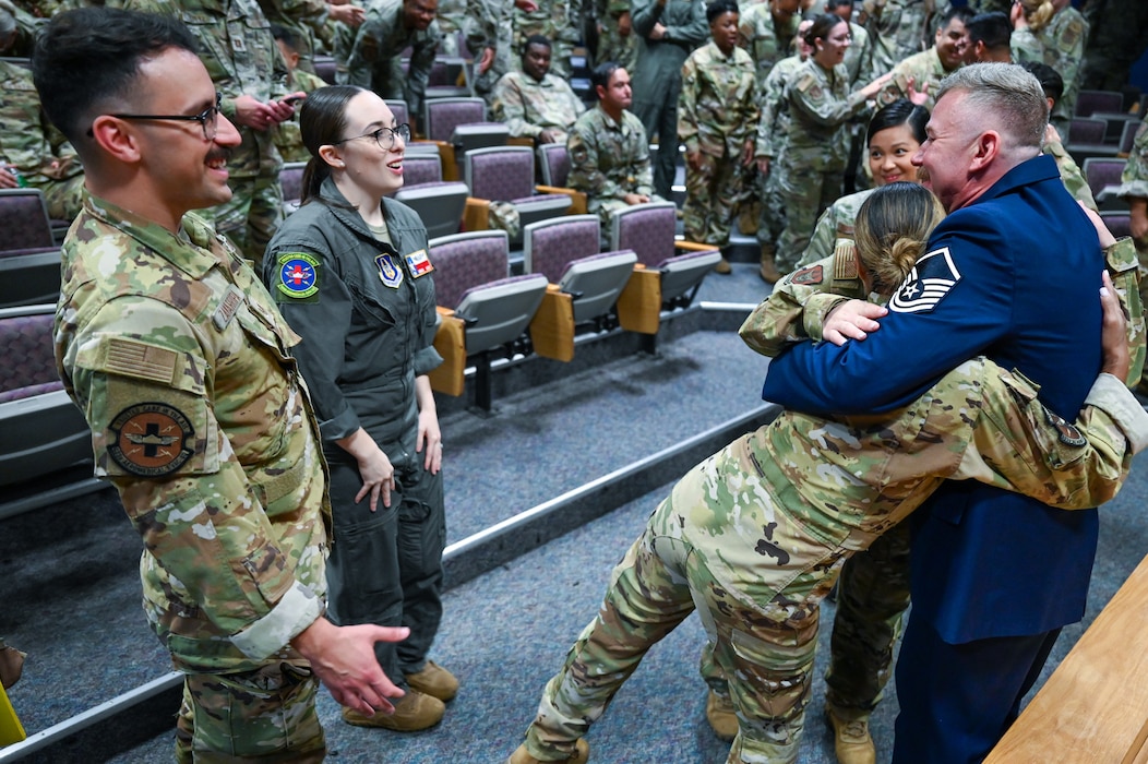 Master Sgt. Raymond Johnson, a 433rd Aeromedical Evacuation Squadron aeromedical evacuation technician, hugs fellow 433rd AES Citizen Airmen after receiving the Distinguished Flying Cross during a ceremony at Joint Base San Antonio-Lackland, Texas Sep. 12, 2024.