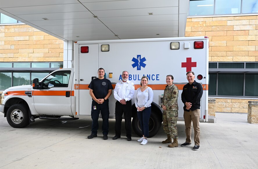 Emergency Center team poses in front of ambulance