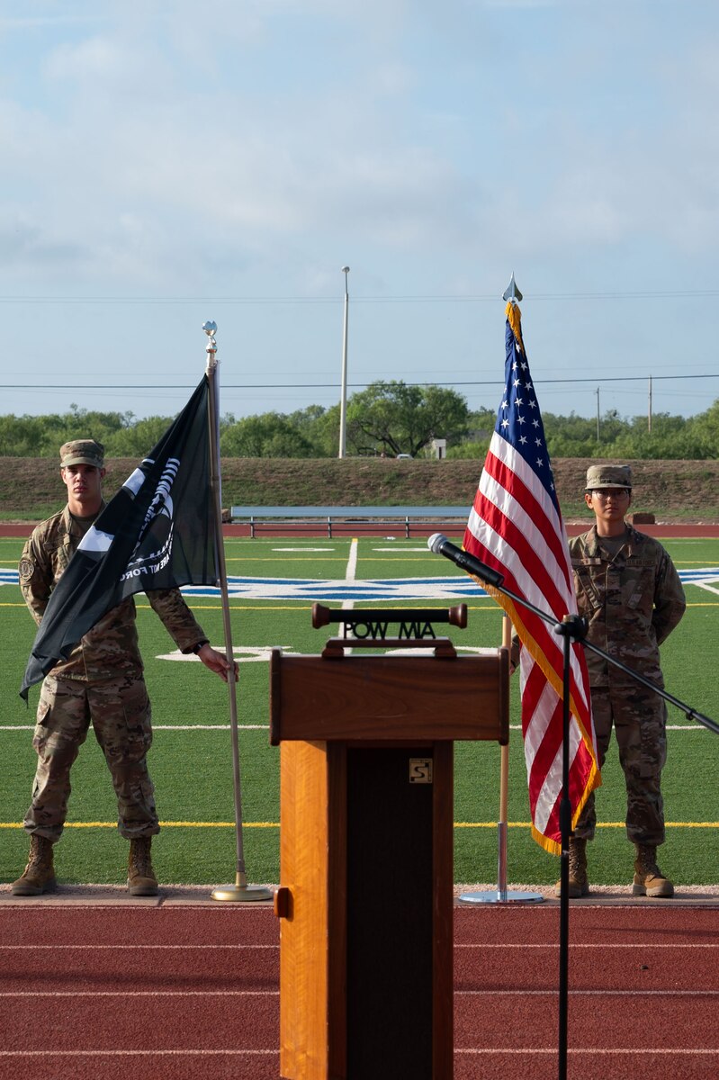 U.S. Air Force students with the 312th Training Squadron hold the U.S. flag and the POW/MIA flag during the POW/MIA Closing Ceremony at the Mathis Fitness Center outdoor track at Goodfellow Air Force Base, Texas, Sept. 20, 2024. National POW/MIA Recognition Day was established in 1979 to be celebrated on the third Friday of September to honor all Americans who were prisoners of war or remain missing in action. (U.S. Air Force photo by Airman 1st Class Brian Lummus)