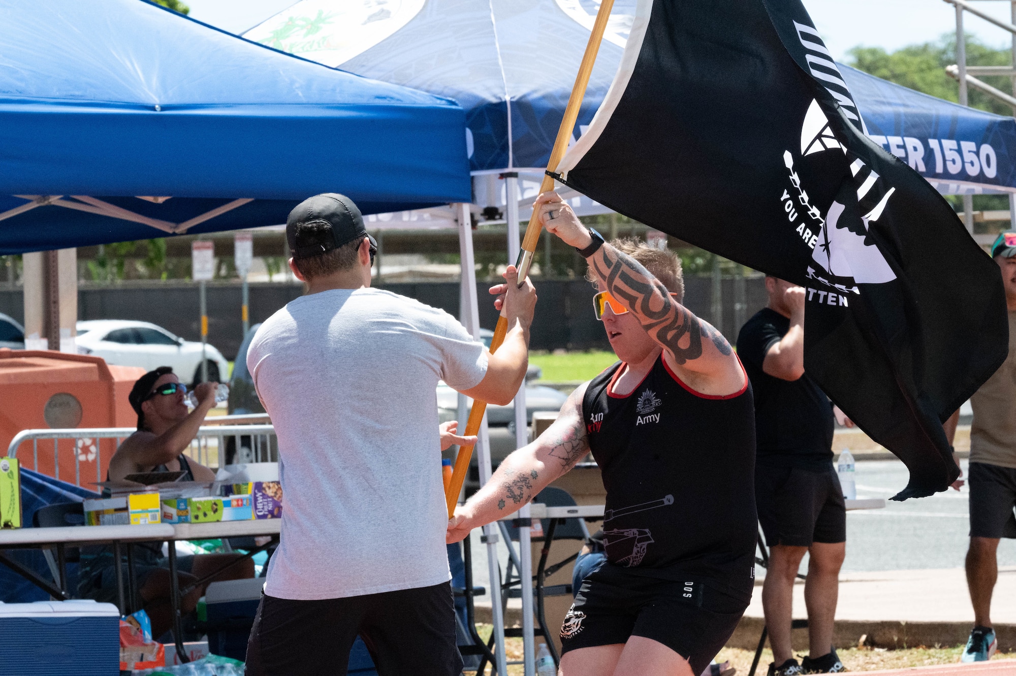 Airmen hand off a POW/MIA flag during a recognition run.