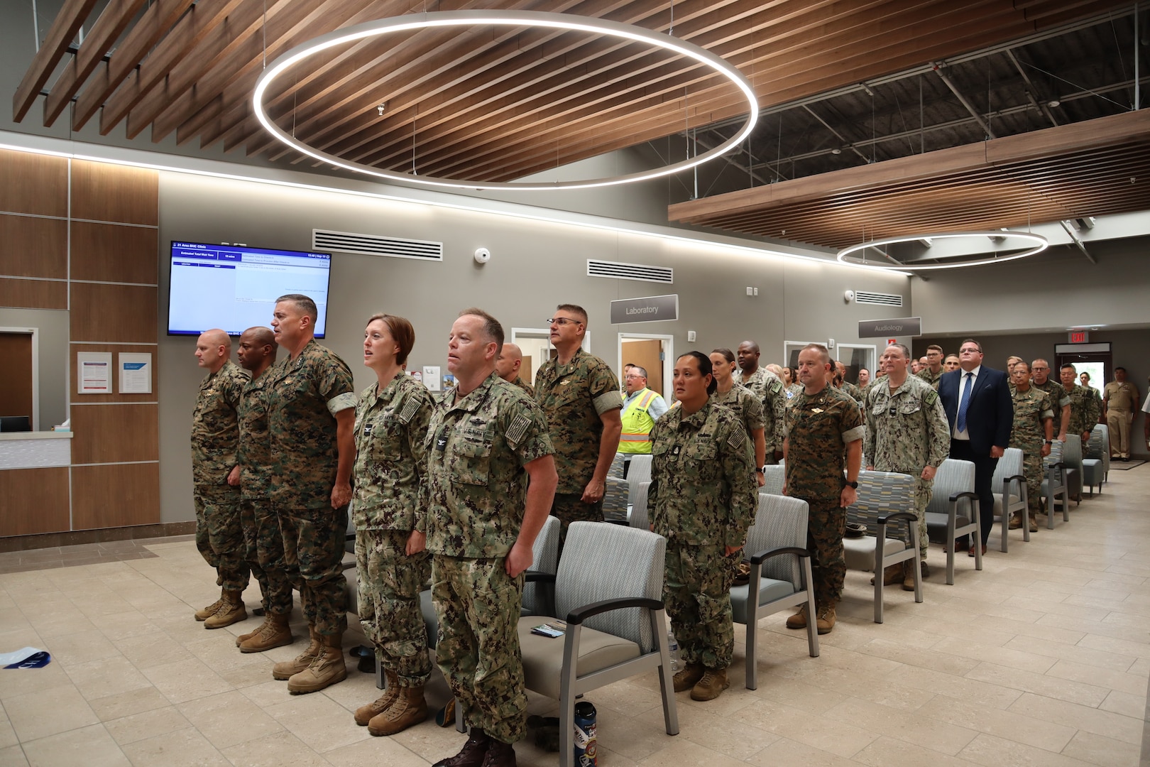 Attendees of the 21 Area Branch Health Clinic ribbon-cutting ceremony stand and sing “Anchors Aweigh” and “The Marine’s Hymn” at the conclusion of the ceremony held aboard Marine Corps Base Camp Pendleton’s Camp Del Mar on Sept. 19, 2024. The new 21 ABHC replaces a clinic constructed in 1966 and provides a state-of-the-art facility where staff from Naval Hospital Camp Pendleton, I Marine Expeditionary Force, 1st Marine Division, and 1st Marine Logistics Group provide medical and dental care to the approximately 5,000 active-duty service members serving aboard Camp Del Mar.