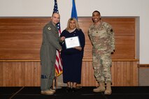 Two men and a woman posing for a photo
