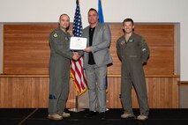 Three men posing for a photo