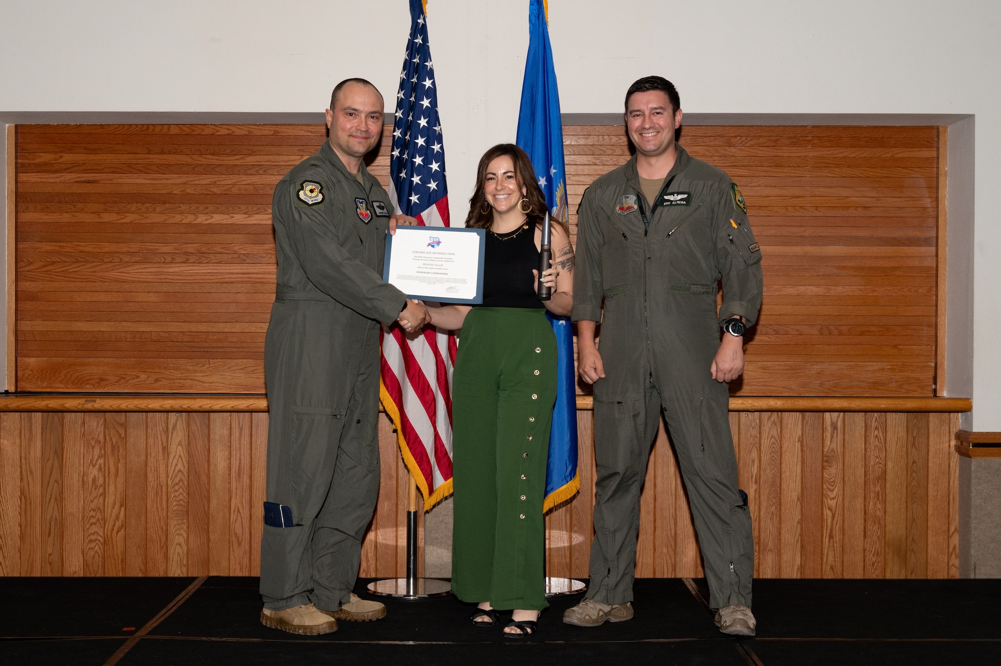 Two men and a woman posing for a photo