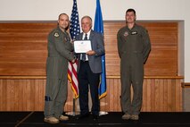Three men posing for a photo