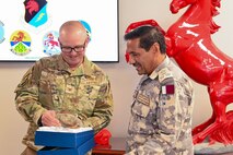 800th REDHORSE Group, commander receives a gift from Qatar Emiri Corps of Engineers commander,