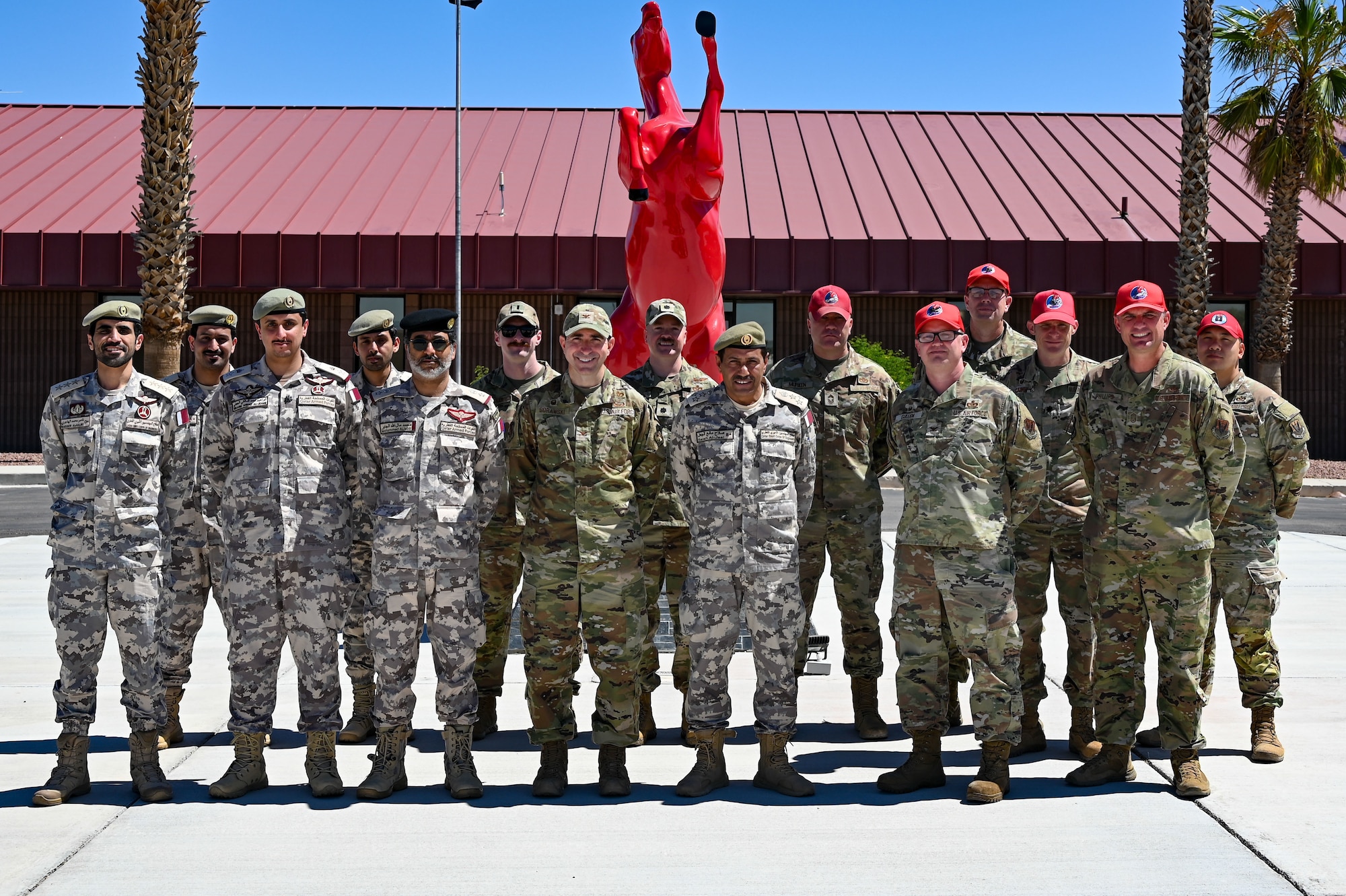 Members from the Qatar Emiri Corps of Engineers, and Airmen assigned to the 800th REDHORSE Group, pose for a photo