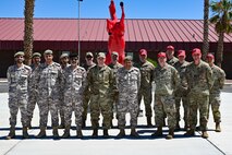 Members from the Qatar Emiri Corps of Engineers, and Airmen assigned to the 800th REDHORSE Group, pose for a photo