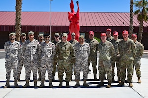 Members from the Qatar Emiri Corps of Engineers, and Airmen assigned to the 800th REDHORSE Group, pose for a photo