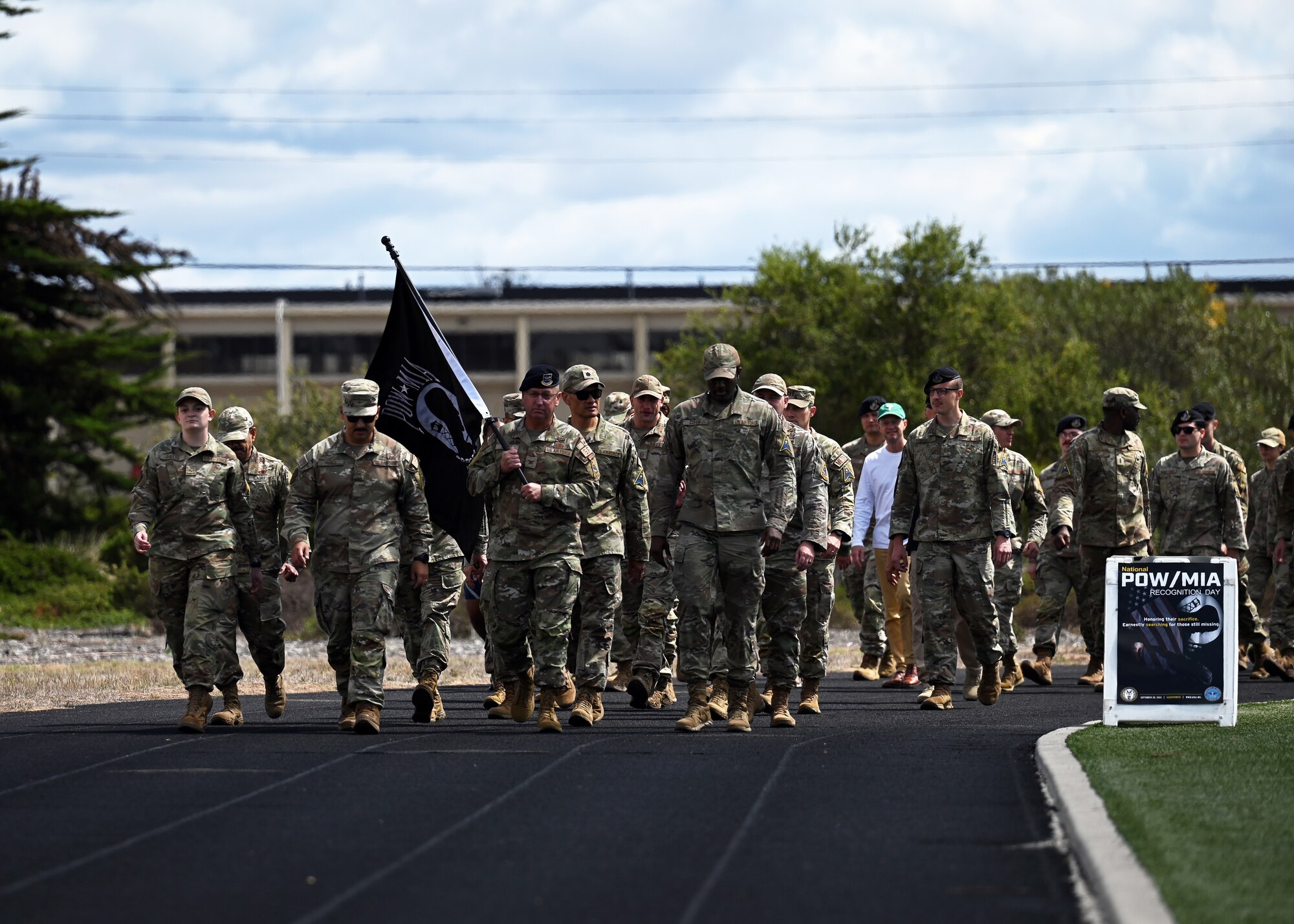 Attendees of the POW/MIA Recognition Day opening ceremony walk the opening lap to the 24-hour, ruck-run-walk event at Vandenberg Space Force Base, Calif., Sept. 19, 2024. During the ruck-run-walk event, members carry the POW/MIA flag to honor and remember those who haven’t yet returned home. (U.S. Space Force photo by Airman 1st Class Olga Houtsma)