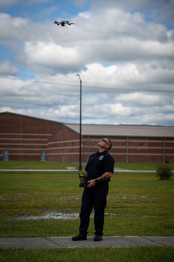 FF Jabbok Ackley, a firefighter with Fire Station 6, Fire and Emergency Services Division (FESD), Marine Corps Base (MCB) Camp Lejeune, pilots a drone at Camp Geiger on MCB Camp Lejeune, North Carolina, Sept. 17, 2024. FESD was given the opportunity to be an early adopter of the small Unmanned Aircraft System program in February 2024 and has since then successfully been used in search and rescue operations. (U.S. Marine Corps photo by Cpl. Leo Amaro)