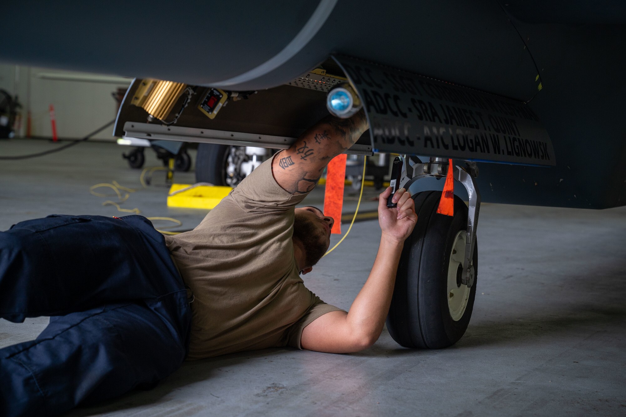 U.S. Air Force Airman 1st Class Benjamin Dallas, 4th Reconnaissance Squadron RQ-4B Global Hawk Crew Chief, inspects the nose landing gear assembly during Preflight inspection on an RQ-4B on Andersen Air Force Base, Guam, Sept. 16, 2024. The RQ-4B is constantly checked before and after each flight, with several members performing routine maintenance checks to ensure capability and safety.  (U.S. Air Force Airman 1st Class Manasseh Demissie)