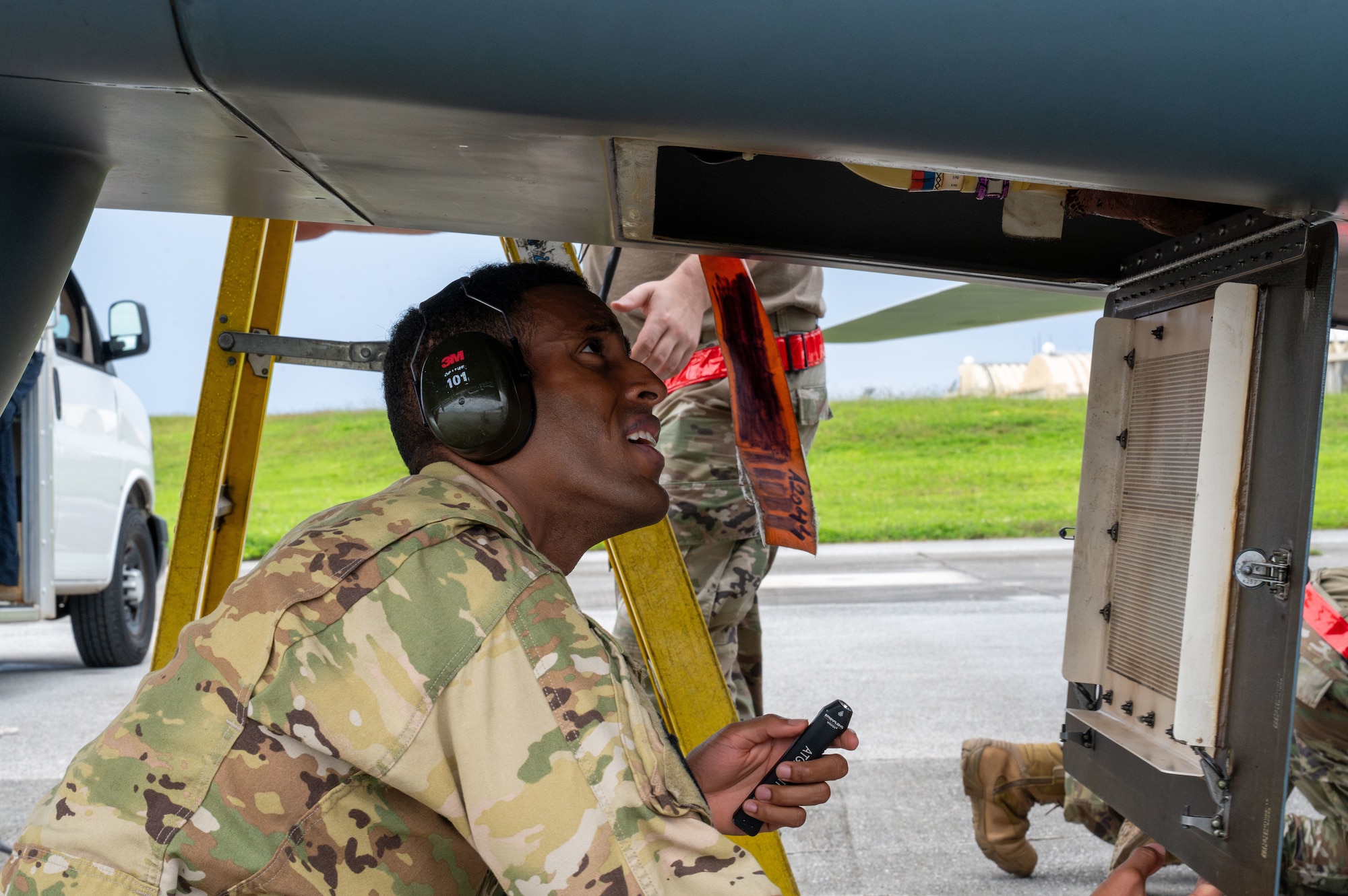 U.S. Air Force 1st Lt. William Harris, 4th Reconnaissance Squadron RQ-4B Global Hawk Pilot, checks for leaks during his aircraft walk-around on Andersen Air Force Base, Guam, Sept. 17, 2024. The RQ-4B is thoroughly inspected before and after each flight, with several members performing routine maintenance checks to ensure capability and safety. (U.S. Air Force Airman 1st Class Manasseh Demissie)