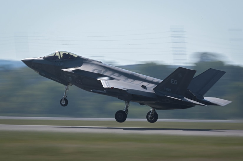 A jet takes off from a flight line.