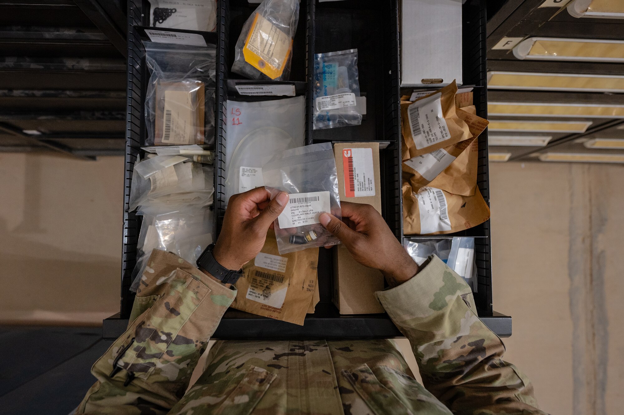 U.S. Air Force 1st Lt. Brian Stone, 378th Expeditionary Communications Squadron plans and resources flight commander, organizes a drawer of supplies at an undisclosed location within the U.S. Central Command area of responsibility, July 12, 2024. Mission-Ready Airmen Cross Utilization Training provides Airmen specific training to perform tasks outside their primary Air Force Specialty Code. (U.S. Air Force photo)