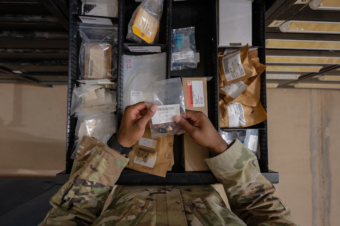 U.S. Air Force 1st Lt. Brian Stone, 378th Expeditionary Communications Squadron plans and resources flight commander, organizes a drawer of supplies at an undisclosed location within the U.S. Central Command area of responsibility, July 12, 2024. Mission-Ready Airmen Cross Utilization Training provides Airmen specific training to perform tasks outside their primary Air Force Specialty Code. (U.S. Air Force photo)
