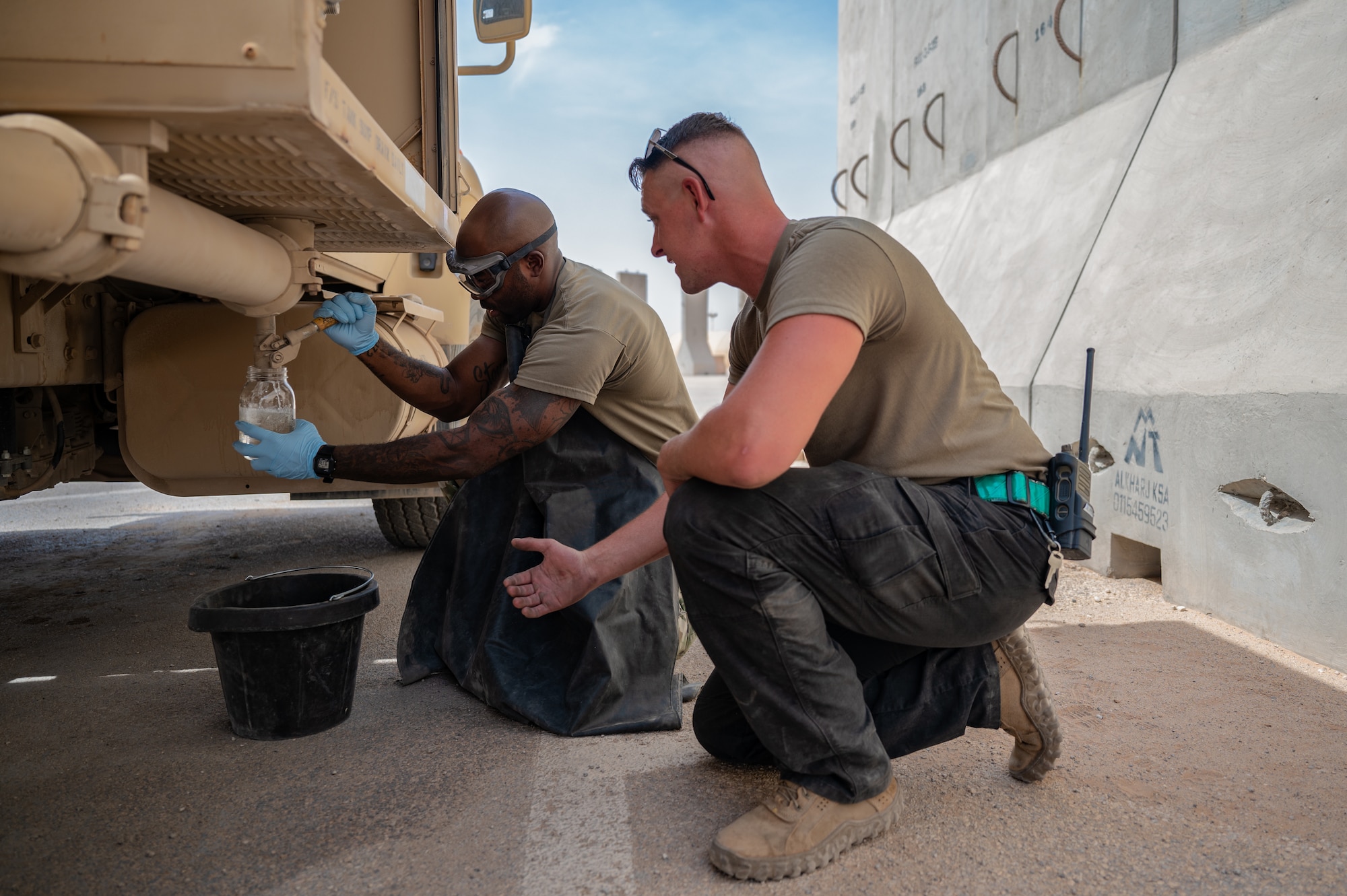 U.S. Air Force 1st Lt. Brian Stone, 378th Expeditionary Communications Squadron plans and resources flight commander, and Staff Sgt. Cristian Kick, 378th Expeditionary Logistics Readiness Squadron fuels equipment maintenance superintendent, test the fuel of a R11 aircraft refueling vehicle at an undisclosed location within the U.S. Central Command area of responsibility, July 12, 2024. The Mission-Ready Airmen concept represents a shift from traditional, large force packages of highly specialized teams toward smaller, multidisciplinary teams that can provide combat support and solve problems with the available resources. (U.S. Air Force photo)