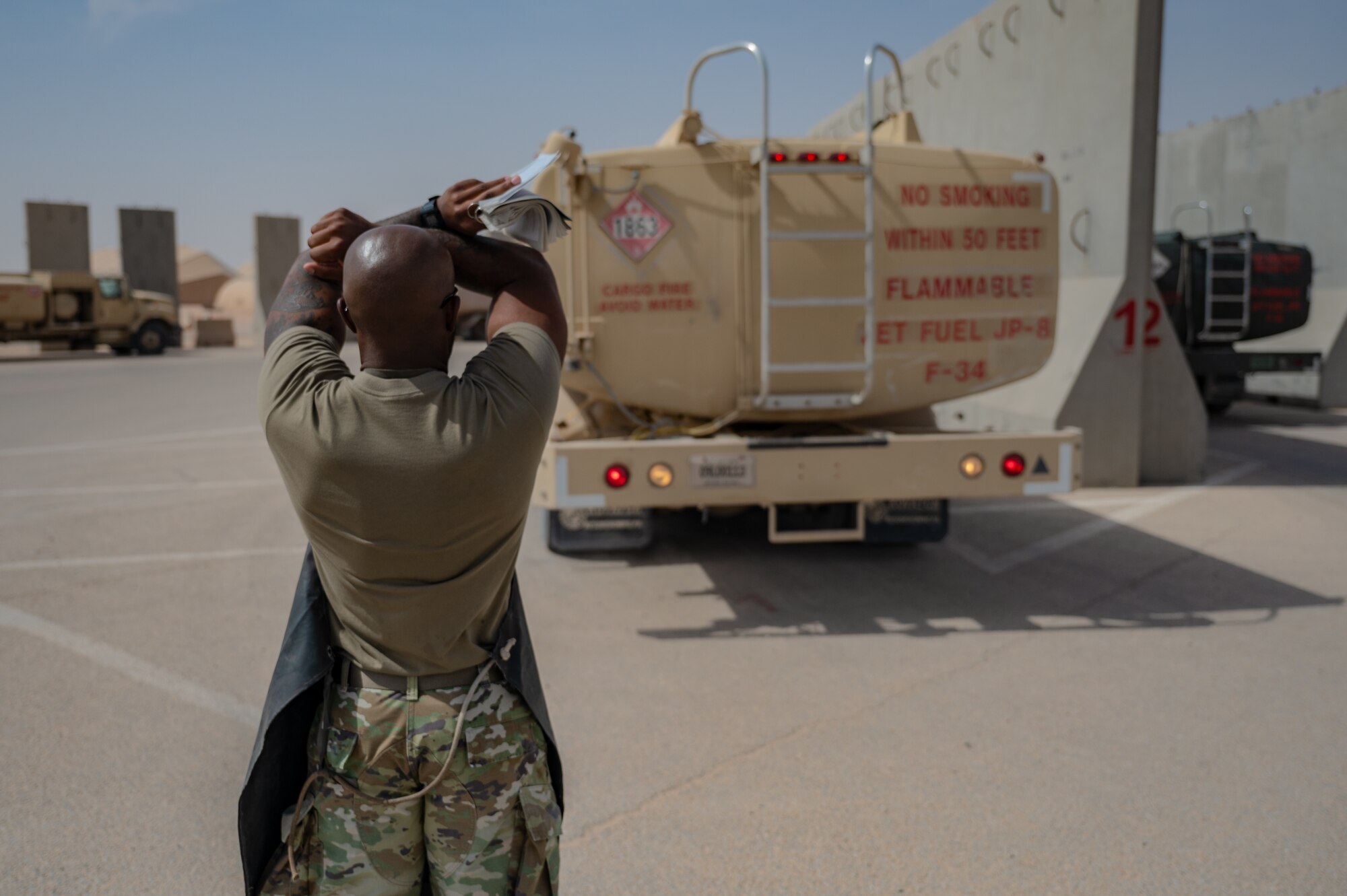 U.S. Air Force 1st Lt. Brian Stone, 378th Expeditionary Communications Squadron plans and resources flight commander, directs a R11 aircraft refueling vehicle at an undisclosed location within the U.S. Central Command area of responsibility, July 12, 2024. By closely integrating alongside the 378th ELRS, Stone is better equipped with greater knowledge of the mission's logistics, as he now sets his sights on a potential role in a combat communications unit. (U.S. Air Force photo)