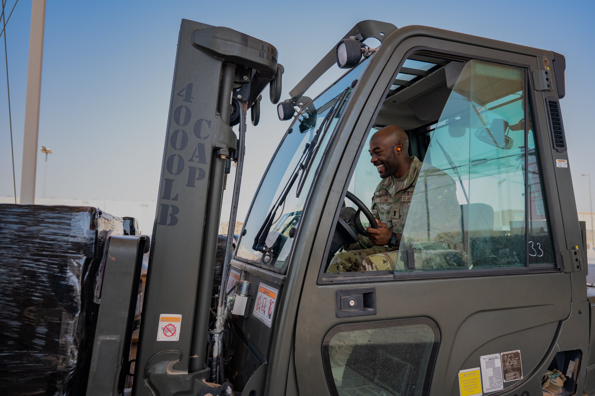 U.S. Air Force 1st Lt. Brian Stone, 378th Expeditionary Communications Squadron plans and resources flight commander, operates a forklift at an undisclosed location within the U.S. Central Command area of responsibility, July 10, 2024. Mission-Ready Airmen Cross Utilization Training provides Airmen specific training to perform tasks outside their primary Air Force Specialty Code. (U.S. Air Force photo)