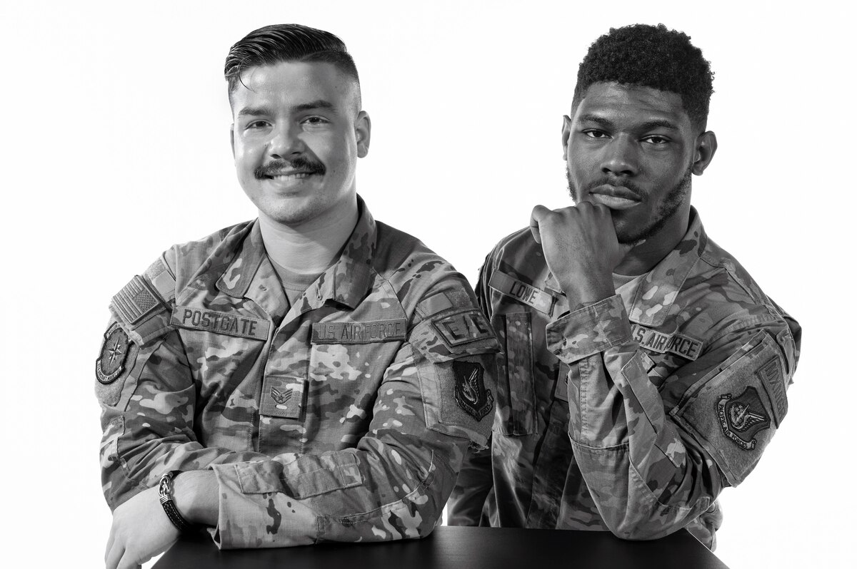 U.S. Air Force Staff Sgt. Boston Postgate, 374th Aircraft Maintenance Squadron electrical and environmental systems craftsman, and Senior Airman Daniel Lowe, 374th AMXS scheduler, pose for a photo at Yokota Air Base, Japan.