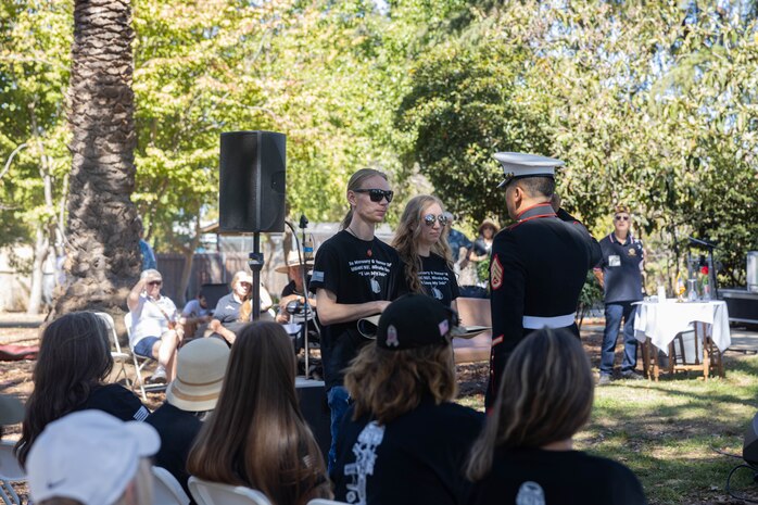 Members of Nicole Gee’s family receive gifts from American Legion Post 637 during a memorial ceremony in Citrus Heights, California, Sept. 14, 2024. A memorial and celebration of life for Gee was held by the American Legion Post 637. During the ceremony, a memorial park bench was unveiled in honor of Gee. (U.S. Marine Corps photo by Staff Sgt. Ryan Harvey)