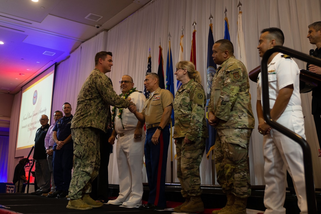 U.S. service members and elected officials congratulate award winners during the Annual Employer Awards Ceremony at the Hyatt Regency, Tumon, Guam, Aug. 29, 2024. The ESGR is a Department of Defense office, which was established in 1972 to promote cooperation and understanding between Reserve Component Service members and their civilian employers and to assist in the resolution of conflicts arising from employee’s military commitment. (U.S. Marine Corps photo by Lance Cpl. Afton Smiley)